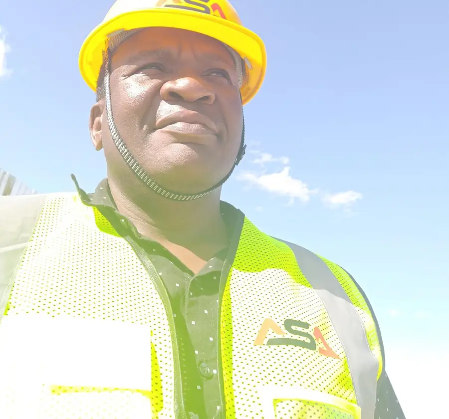 ASA site supervisor wearing an ASA-branded hard hat and high-visibility vest